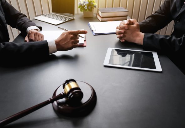 midsection-lawyer-client-discussing-table