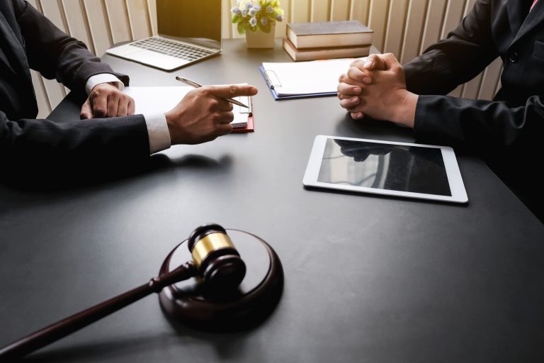 midsection-lawyer-client-discussing-table